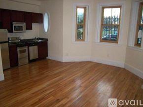 Boston apartment for rent - A kitchen with wooden floors and white walls.