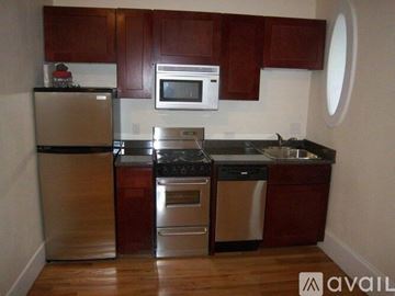 Boston apartment for rent - A kitchen with brown cabinets and stainless steel appliances.