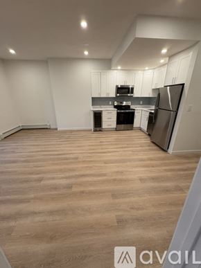 Boston apartment for rent - A kitchen with wooden floors and white walls.