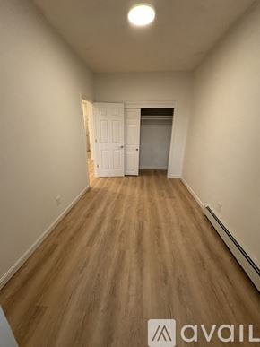 Boston apartment for rent - A room with wooden flooring and a white door.