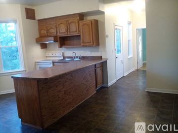 Appleton apartment for rent - A kitchen with wooden cabinets and a wooden island.