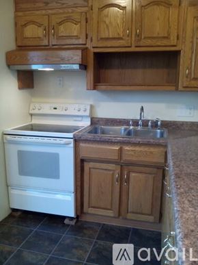 Appleton apartment for rent - A kitchen with a white oven and wooden cabinets.
