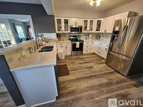 Oakland Park house for rent - A kitchen with a white counter and stainless steel appliances.