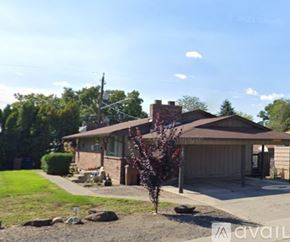 Spokane house for rent - A house with a brown roof and a brown garage door is for sale.