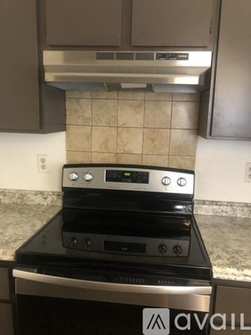 Spokane house for rent - A stainless steel oven with a digital display is built into a kitchen counter.