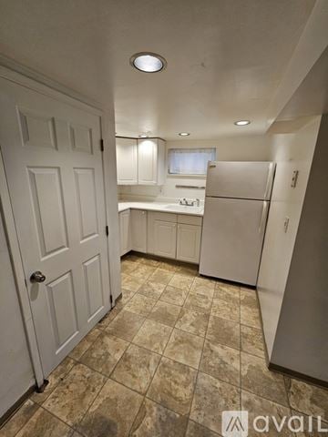 Seattle townhouse for rent - A kitchen with a white door and a white fridge.