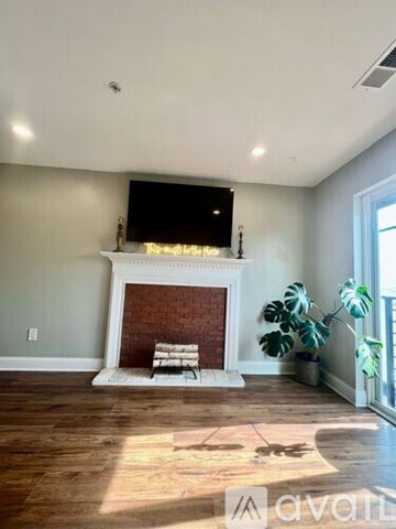 Washington condo for rent - A living room with a fireplace and a tv above it.
