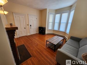 Quincy apartment for rent - A living room with a grey couch and a wooden coffee table.