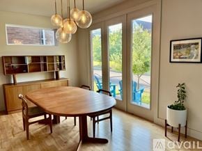 St. Louis house for rent - A dining room with a wooden table and chairs, a plant, and a framed picture on the wall.