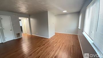 Muncie apartment for rent - A room with wooden flooring and white walls is available for rent.