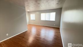 Muncie apartment for rent - A room with wooden flooring and two windows.