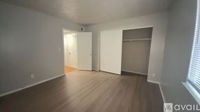 Muncie apartment for rent - A room with a white door and a window with blinds.