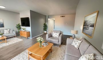 Muncie apartment for rent - A kitchen with a white refrigerator, white stove, and wooden cabinets.