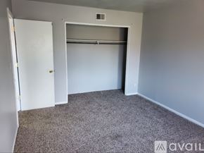 Muncie apartment for rent - A room with a carpeted floor and a white door.