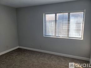 Muncie apartment for rent - A room with a carpeted floor and a window with blinds.
