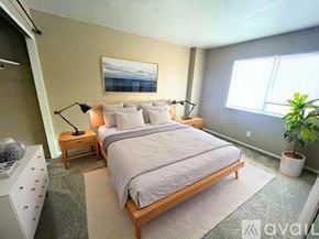 Muncie townhouse for rent - A spacious room with wooden flooring and a staircase.