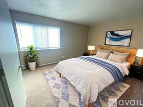 Muncie townhouse for rent - A carpeted room with a window and a door.