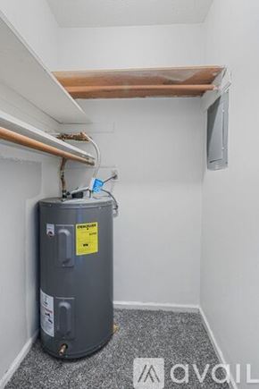Muncie apartment for rent - A water heater in a room with a grey floor and white walls.
