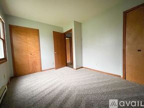 Muncie apartment for rent - A room with a carpeted floor and three doors.