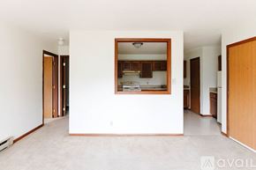 Garrett apartment for rent - A kitchen area is visible through a window in a white room.