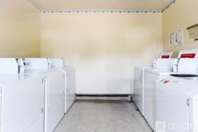 Garrett apartment for rent - A laundry room with washing machines and a dryer.