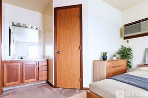 Lagrange apartment for rent - A bedroom with a bed, dresser, and mirror.