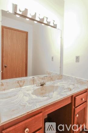 Lagrange apartment for rent - A bathroom with a marble counter top and a wooden door.