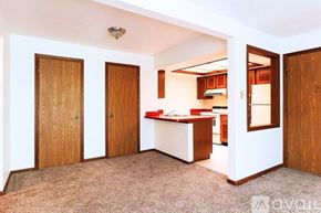 Lagrange apartment for rent - A kitchen area with a counter and cabinets is visible through an open door.