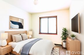 Lagrange apartment for rent - A well-lit bedroom with a bed, nightstand, and a window.