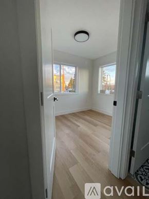 Schiller Park apartment for rent - A room with wooden flooring and a window showing trees outside.