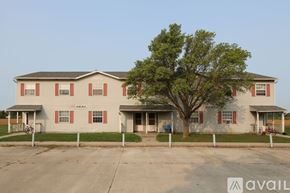 Woodburn apartment for rent - A two-story house with a tree in front.