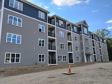 Shelton apartment for rent - A large building with multiple balconies and windows is under construction.