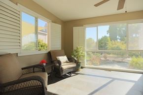 San Jose house for rent - A sunny patio with a couch, chair, and table.