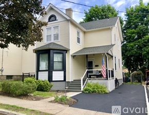 Highland Falls house for rent - A house with a flag on the porch and a driveway in front.