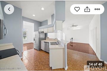 Palm Bay house for rent - A modern kitchen with a refrigerator, dishwasher, and stove top.