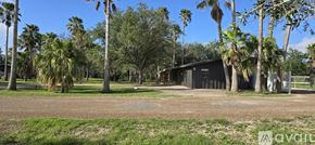 Donna apartment for rent - A building surrounded by palm trees with a sign that says "available".