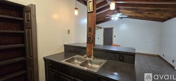 Donna apartment for rent - A kitchen with a sink and a wooden beam on the wall.