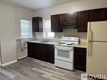 Waterbury apartment for rent - A kitchen with a white stove and brown cabinets.