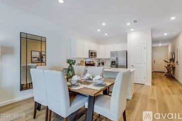 Orange Park townhouse for rent - A dining room with a table set for two and a kitchen in the background.
