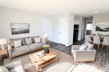 Milroy apartment for rent - A living room with a grey couch, a wooden coffee table, and a painting on the wall.