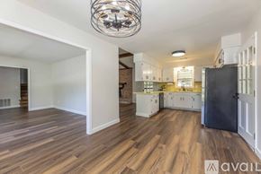 Columbus house for rent - A spacious family room with a fireplace and wooden floors.