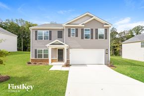 King house for rent - A grey house with a white garage door is for sale by FirstKey Homes.