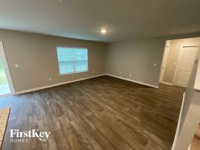 King house for rent - A room with wooden flooring and a window with blinds.
