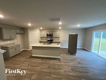 King house for rent - A kitchen with a white counter top and a refrigerator.