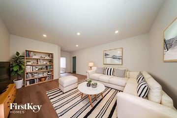 Tuttle house for rent - A living room with a white couch and a coffee table.