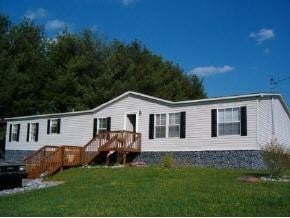 Telford house for rent - A white mobile home with a brown deck.