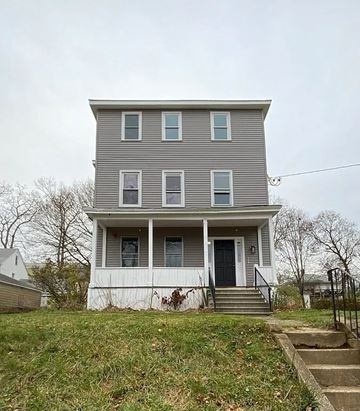 Southbridge apartment for rent - A two-story house with a front porch and a black door.