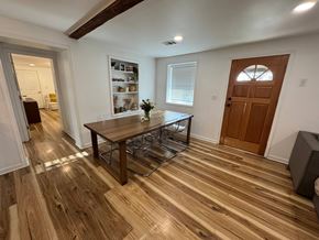 Louisville house for rent - A room with a wooden floor and a brown door.