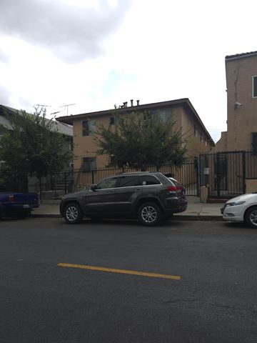 Los Angeles apartment for rent - A black SUV is parked in a parking space on a cloudy day.