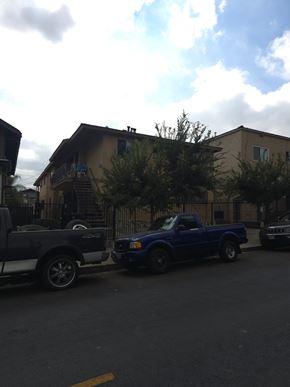 Los Angeles apartment for rent - Two trucks parked in front of a house.